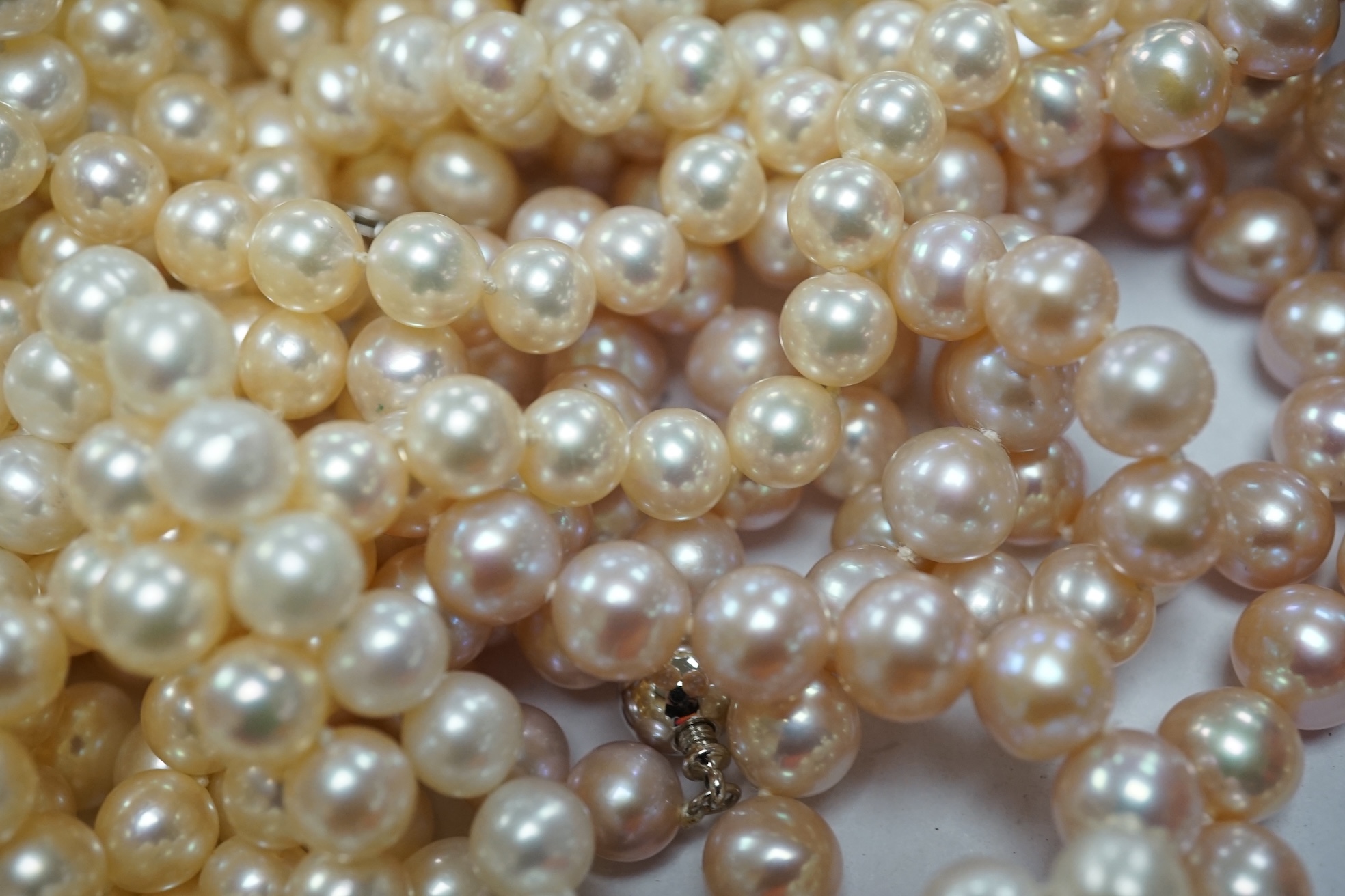 Six assorted modern single strand cultured pearl necklaces, one with 14k clasp, longest 86cm, a pair of similar bracelets, 18cm and a freshwater pearl multi strand necklace. Condition - fair to good